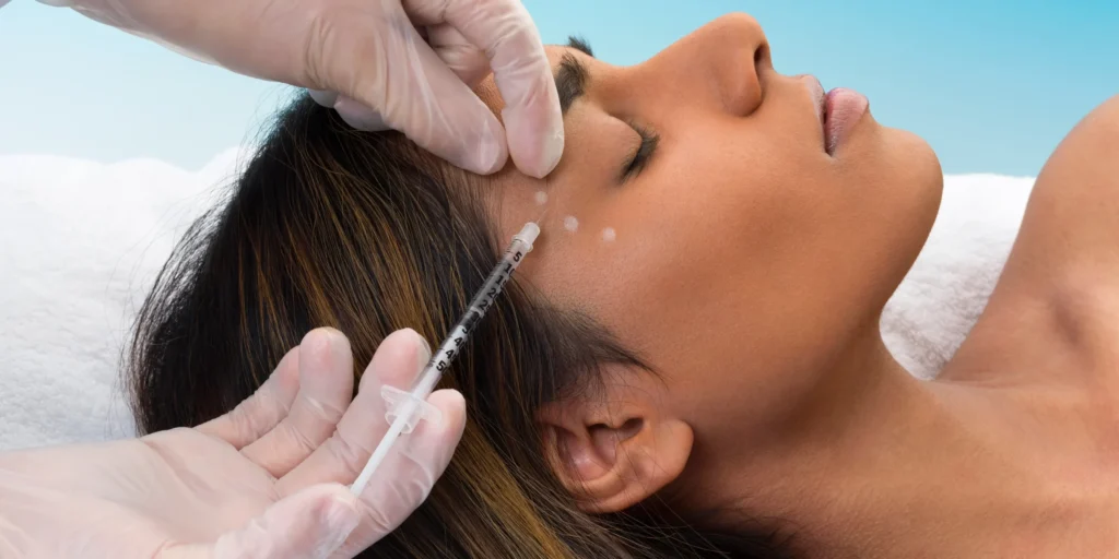 botox injection in the area around the eye, demonstration on a woman